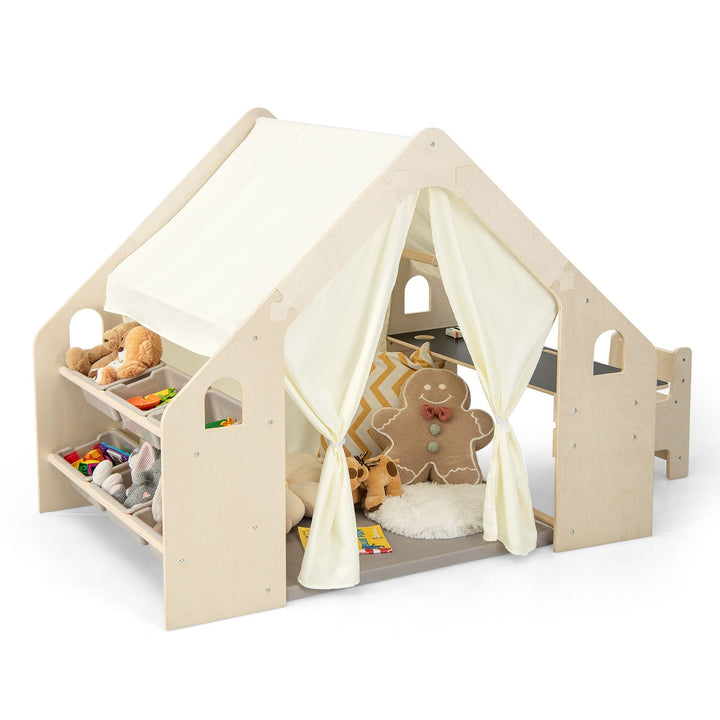 Beige wooden indoor playhouse showing its six storage bins, fabric roof and example toys and cushions
