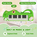 Green 25-key dinosaur toy keyboard with keyboard and music mode controls and light