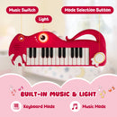 Red 25-key dinosaur toy keyboard with keyboard and music mode controls and light