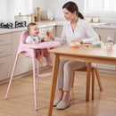 4-in-1 Baby High Chair with Adjustable Footrest – Pink high chair beside a dining table