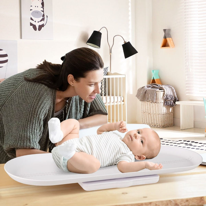 White baby scale with detachable tray during supervised weighing