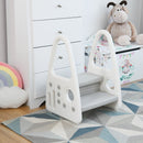 Grey step stool beside a chest of drawers, showing its side panel and foot pads