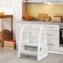 Grey and white two-step stool beside a kitchen cabinet