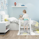 Child holding both side handles while standing on the lower step of the Grey stool