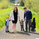 Black tandem double stroller, folded stroller during an outing