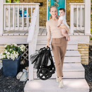 Grey reversible stroller, folded stroller being carried