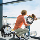 Black penguin suitcase beside a child wearing the matching backpack at an airport window with an adult.
