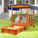 Canopied playhouse and sandpit in an outdoor setting