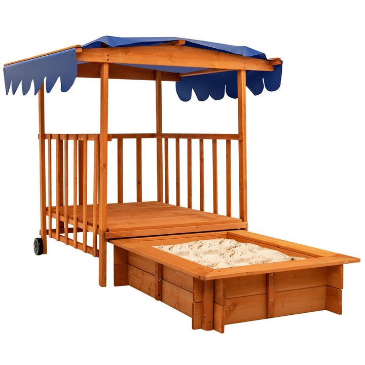 Cedar playhouse with blue canopy and separate sandpit