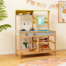 Wooden mud kitchen in a room setting; cookware, toy food, utensils, plant, basket and decorative props are not included