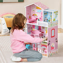 Pink wooden dollhouse in a playroom setting