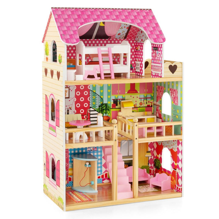 Assembled pink three-storey dollhouse with furnished rooms