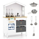 White house-shaped wooden play kitchen, cookware and utensils