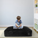 Black foam-block crash pad shown during seated reading