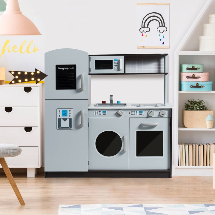 Grey wooden play kitchen with toy fridge, washing machine, oven, sink and microwave