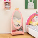 Pink crown-top dressing mirror with a lower shelf beside a unicorn-themed bed.