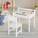 White drawing table and chair with paper roll in a playroom