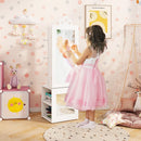 Child standing beside the white cabinet with the mirrored door closed