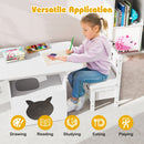 Child drawing at the white table beside the cat compartment