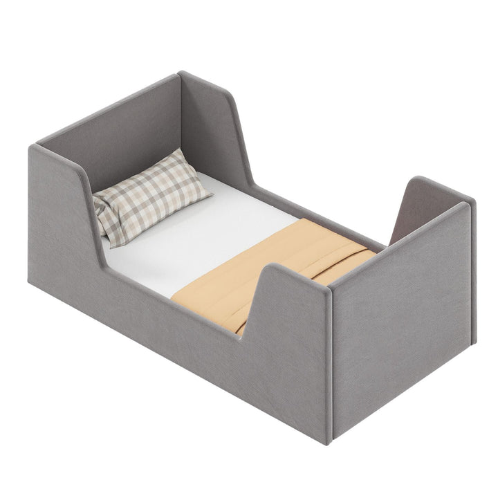 Grey velvet upholstered toddler bed frame with shaped side panels
