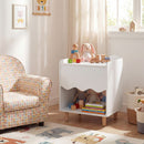 White nightstand with open shelf in a reading corner
