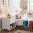 White bedside table in a styled bedroom