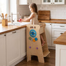 Natural wooden standing activity tower used at a counter