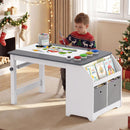 Child drawing at the grey and white art table