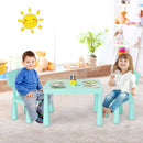 Green kids plastic table and two-chair set: two children with books in a room.