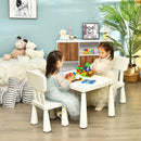 White kids plastic table and two-chair set: two children playing in a room.