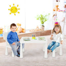 White kids plastic table and two-chair set: two children with books in a room.