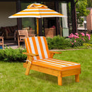 Yellow and white striped kids chaise lounge and umbrella in a garden