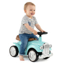 Child seated on retro ride-on car – Green