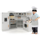 White corner play kitchen with a child wearing the included-style chef outfit