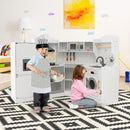 White corner play kitchen with two children at play