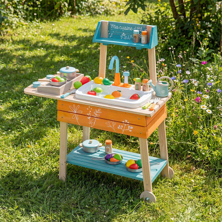 Multicolour outdoor mud kitchen with circulation sink and two wheels; cookware, food and props are not included
