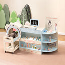 Blue pretend doctor station and wheeled toy trolley shown with example soft toys