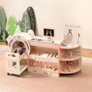 Pink pretend doctor station and wheeled toy trolley shown with example soft toys