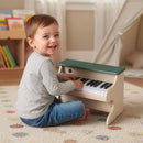 Green and beige 25-key toy piano shown in a playroom