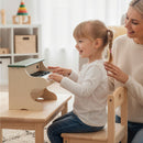 Green and beige toy piano used on a table