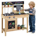 Child beside the Natural mud kitchen and water tank with example plants and play accessories