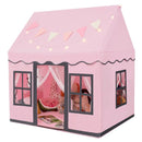 Pink house-style play tent with dark window trim, banner and star lights; decorative props shown