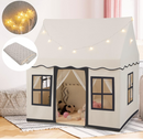 Beige house-style play tent with grey window trim and star lights; decorative props shown