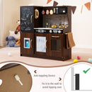 Wooden play kitchen with chalkboard and toy ice dispenser, Brown — wall anchoring detail and room setting