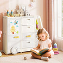Beige and grey bus-shaped toy storage unit beside a child reading in a playroom