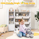 White kids storage organiser with eight bins and a side cabinet: child beside organiser