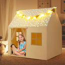 Beige star-roof play tent shown during seated play with its decorative lights illuminated
