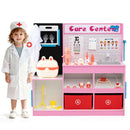 Child standing beside the pink doctor play centre and its supplied toy accessories