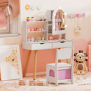 White vanity and chair viewed from the side with example dressing-up accessories