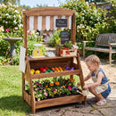 Brown wooden market stand with its lower bin staged as a planter; plants and tools are not included